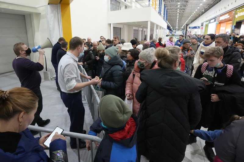 People wait in a line to enter the IKEA store at the outskirts of St. Petersburg, Russia, Thursday, March 3, 2022. IKEA is closing its stores and pausing all sourcing in Russia and Belarus from Friday, March 4. 