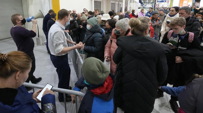 People wait in a line to enter the IKEA store at the outskirts of St. Petersburg, Russia, Thursday, March 3, 2022. IKEA is closing its stores and pausing all sourcing in Russia and Belarus from Friday, March 4. 