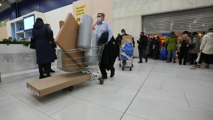 People wait in a line to enter the IKEA store at the outskirts of St. Petersburg, Russia, Thursday, March 3, 2022. IKEA is closing its stores and pausing all sourcing in Russia and Belarus from Friday, March 4. 