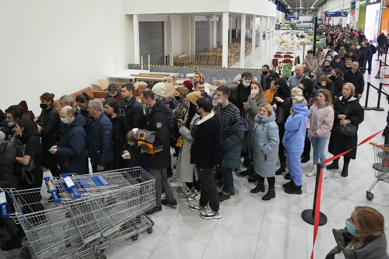People wait in a line to enter the IKEA store at the outskirts of St. Petersburg, Russia, Thursday, March 3, 2022. IKEA is closing its stores and pausing all sourcing in Russia and Belarus from Friday, March 4. 