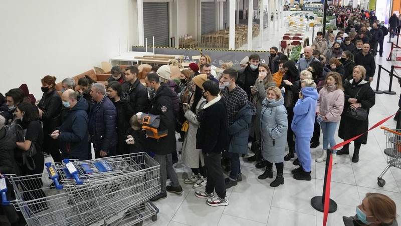People wait in a line to enter the IKEA store at the outskirts of St. Petersburg, Russia, Thursday, March 3, 2022. IKEA is closing its stores and pausing all sourcing in Russia and Belarus from Friday, March 4. 