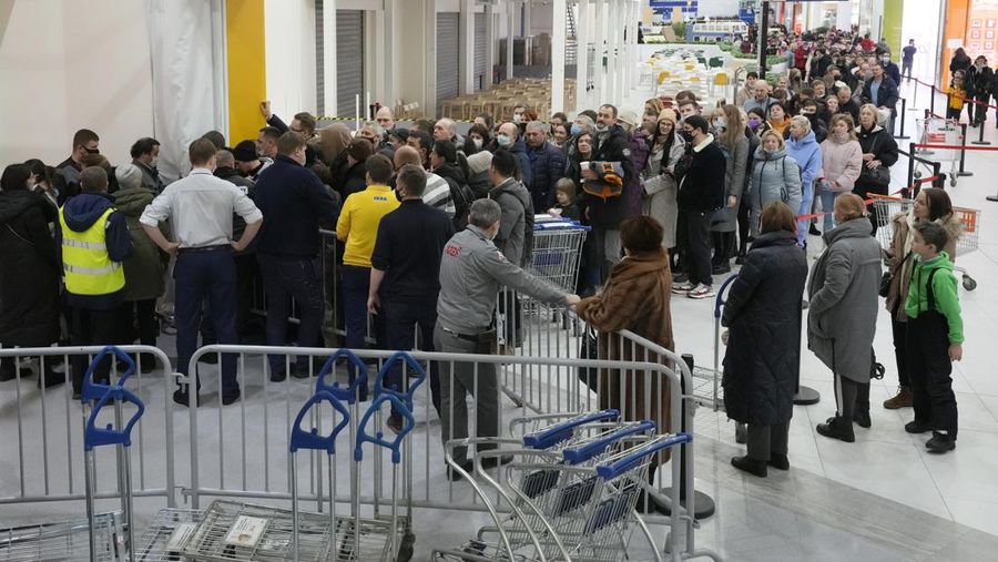 People wait in a line to enter the IKEA store at the outskirts of St. Petersburg, Russia, Thursday, March 3, 2022. IKEA is closing its stores and pausing all sourcing in Russia and Belarus from Friday, March 4. 