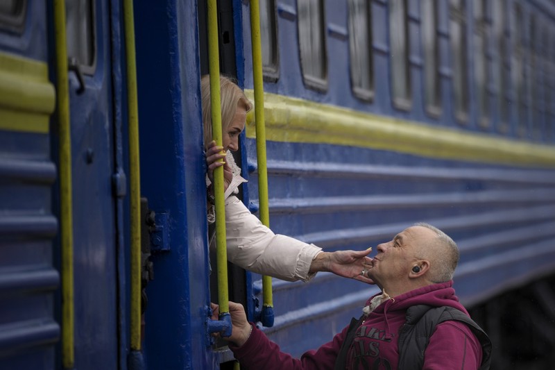 A couple says goodbye before she boards on a train bound for Lviv at the Kyiv station, Ukraine, Thursday, March 3. 2022. (AP Photo/Emilio Morenatti)