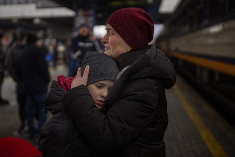A couple says goodbye before she boards on a train bound for Lviv at the Kyiv station, Ukraine, Thursday, March 3. 2022. (AP Photo/Emilio Morenatti)