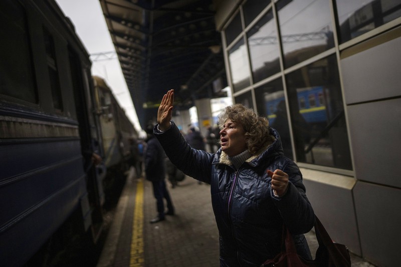 A couple says goodbye before she boards on a train bound for Lviv at the Kyiv station, Ukraine, Thursday, March 3. 2022. (AP Photo/Emilio Morenatti)