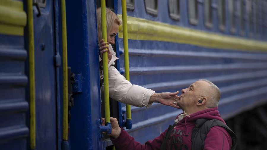 A couple says goodbye before she boards on a train bound for Lviv at the Kyiv station, Ukraine, Thursday, March 3. 2022. (AP Photo/Emilio Morenatti)