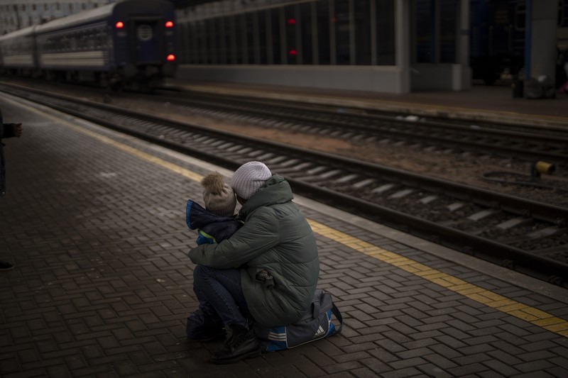 A couple says goodbye before she boards on a train bound for Lviv at the Kyiv station, Ukraine, Thursday, March 3. 2022. (AP Photo/Emilio Morenatti)
