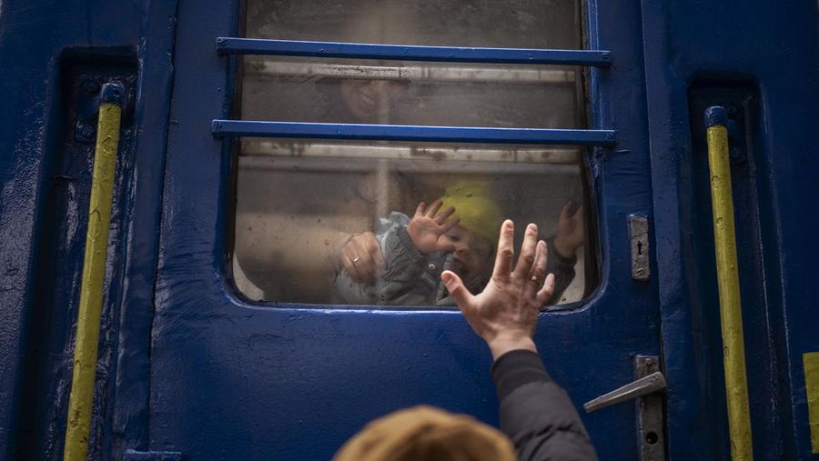 A couple says goodbye before she boards on a train bound for Lviv at the Kyiv station, Ukraine, Thursday, March 3. 2022. (AP Photo/Emilio Morenatti)