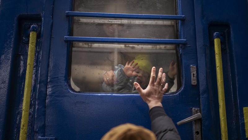 A couple says goodbye before she boards on a train bound for Lviv at the Kyiv station, Ukraine, Thursday, March 3. 2022. (AP Photo/Emilio Morenatti)