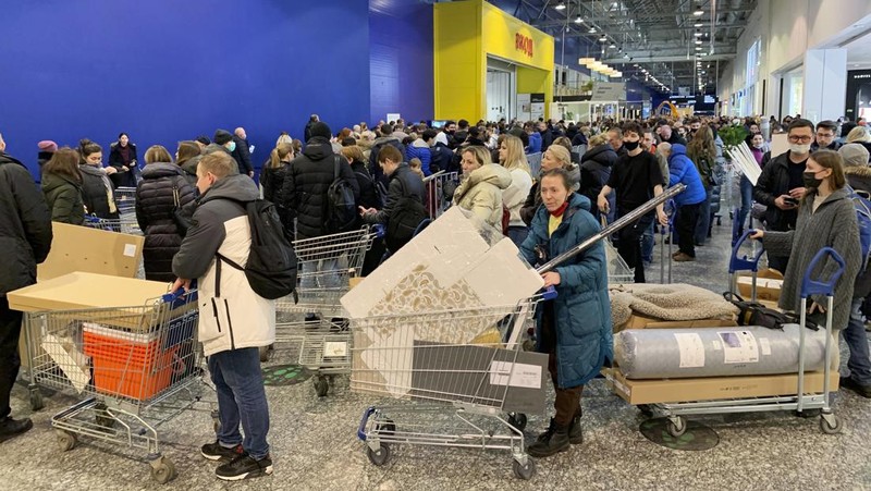 People wait in a line to enter the IKEA store at the outskirts of St. Petersburg, Russia, Thursday, March 3, 2022. IKEA is closing its stores and pausing all sourcing in Russia and Belarus from Friday, March 4. 