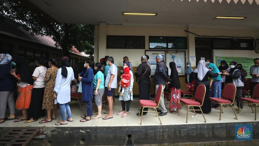 Warga antre untuk mendapatkan minyak goreng kemasan di GOR BRI, Radio Dalam, Jakarta, Senin (7/2/2022). Polsek Kebayoran Baru menggelar oprasi pasar minyak goreng murah mulai tanggal 7-9 Maret 2022. (CNBC Indonesia/ Tri Susilo)