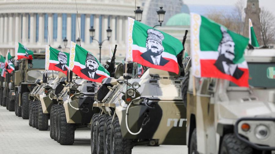 Prajurit mengendarai mobil pengangkut personel lapis baja dengan bendera yang menampilkan gambar mantan pemimpin Chechnya Akhmad Kadyrov saat mengikuti pidato kepala Republik Chechnya Ramzan Kadyrov saat dipersiapkan sebagai antisipasi saat konflik militer Rusia-Ukraina di Grozny, Rusia Jumat (25/2/2022). (REUTERS/Chingis Kondarov)