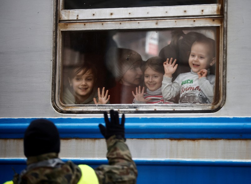 Relawan membagikan makanan kepada orang-orang yang melintasi perbatasan dari Ukraina ke Polandia, setelah melarikan diri dari iserangan Rusia ke Ukraina, di pos pemeriksaan perbatasan di Medyka, Polandia, Selasa (8/3/2022). (REUTERS/Fabrizio Bensch)