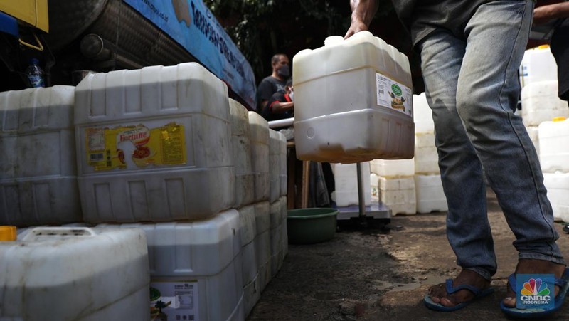 Pedagang antre untuk mendapatkan minyak curah di Pasar Kebayoran Lama, Jakarta, Rabu (9/3/2022). Kemendag dan BUMN menyediakan sebanyak 8000 liter minyak goreng untuk didistribusikan. (CNBC Indonesia/ Tri Susilo)