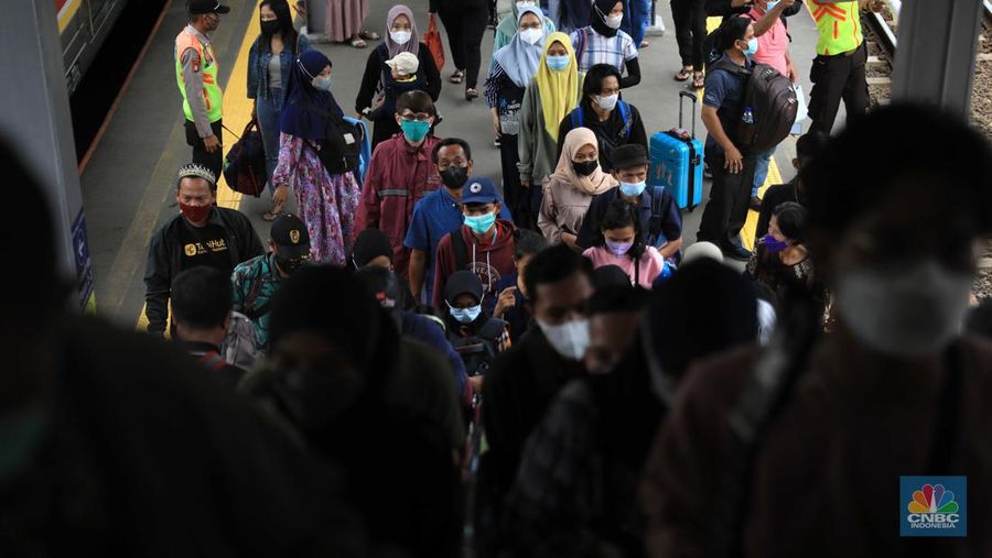 Penumpang berjalan menuju peron unuk menaiki KRL Commuter Line di Stasiun Tanah Abang, Jakarta, Rabu (9/3/2022). Petugas KAI Commuter telah mencabut dan membersihkan marka jaga jarak yang sebelumnya ada dari tempat duduk di KRL. (CNBC Indonesia/ Muhammad Sabki)