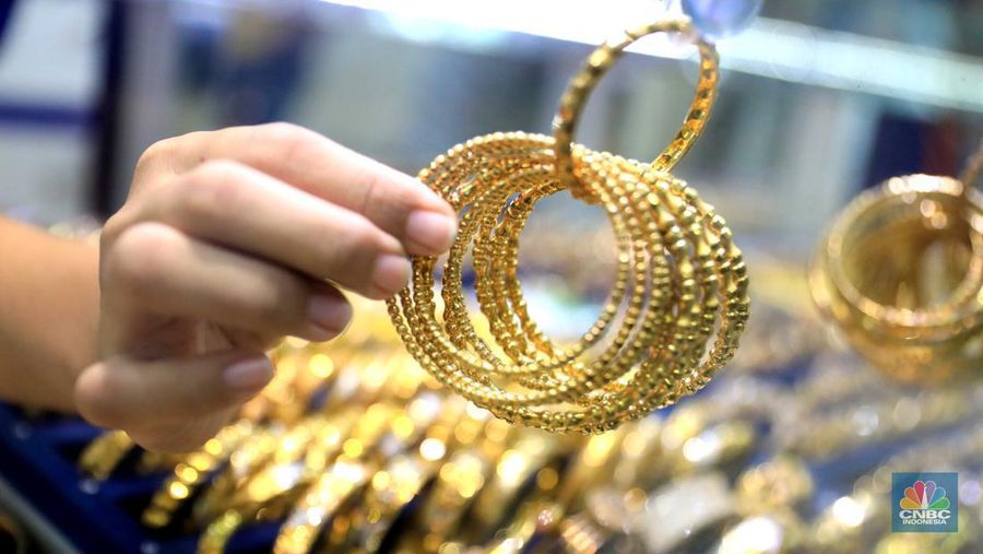 Pekerja menata perhiasan emas di toko emas Kawasan Pasar Ciputat, Tangerang Selatan, Jumat (11/3/2022). Harga emas dunia bergerak melemah pada perdagangan hari ini.  (CNBC Indonesia/ Muhammad Sabki)