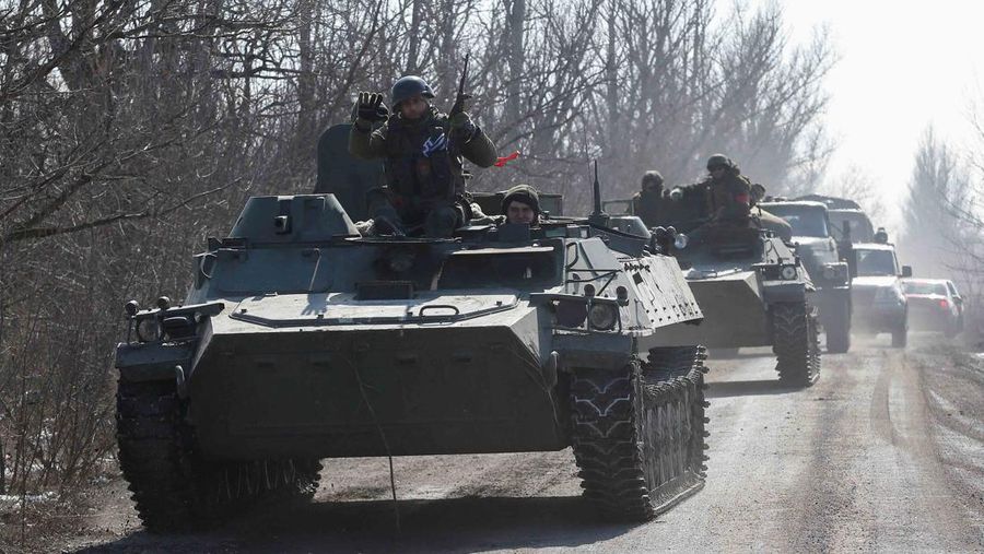 Service members of pro-Russian troops in uniforms without insignia are seen atop of armoured vehicles during Ukraine-Russia conflict outside the separatist-controlled town of Volnovakha in the Donetsk region, Ukraine March 12, 2022. REUTERS/Alexander Ermochenko
