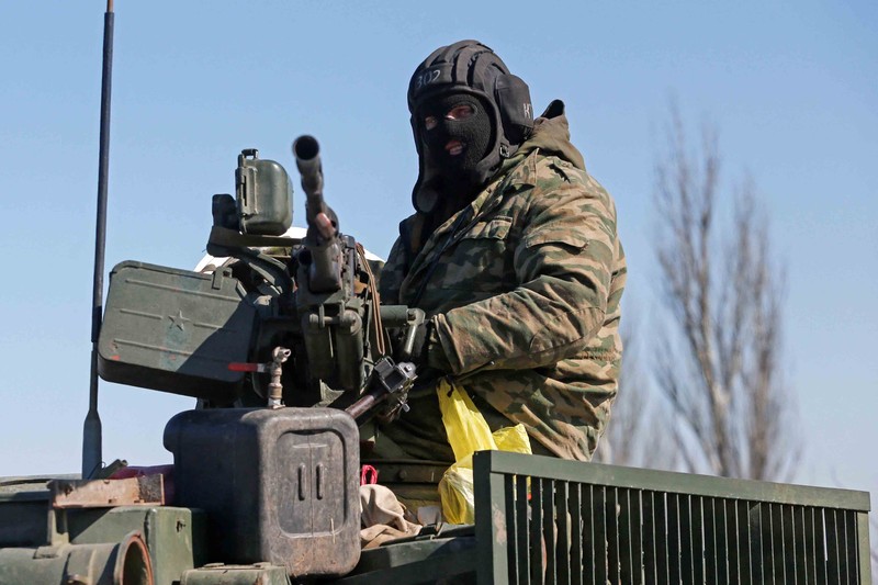 UKRAINE-CRISIS/DONETSK-REGION Service members of pro-Russian troops in uniforms without insignia are seen atop of armoured vehicles during Ukraine-Russia conflict outside the separatist-controlled town of Volnovakha in the Donetsk region, Ukraine March 12, 2022. REUTERS/Alexander Ermochenko