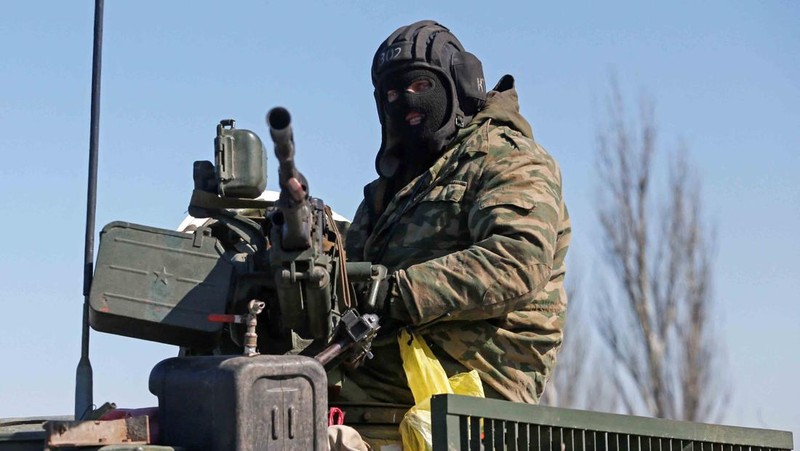 Service members of pro-Russian troops in uniforms without insignia are seen atop of armoured vehicles during Ukraine-Russia conflict outside the separatist-controlled town of Volnovakha in the Donetsk region, Ukraine March 12, 2022. REUTERS/Alexander Ermochenko