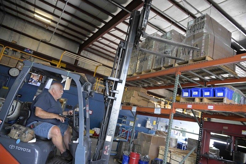 Adrian Kellgren, director of industrial production of KelTec, holds a 9mm SUB2000 rifle, similar to ones being shipped to Ukraine, at their manufacturing facility on Thursday, March 17, 2022, in Cocoa, Fla. Kellgren’s family-owned gun company was left holding a $200,000 shipment of semi-automatic rifles after a longtime customer in Odessa suddenly went silent during Vladimir Putin’s invasion of Ukraine. Fearing the worst, the company decided to put those stranded 400 guns to good use, sending them to Ukraine's nascent resistance movement. (AP Photo/Phelan M. Ebenhack)