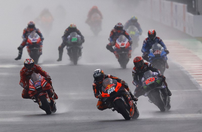 Miguel Oliveira dari Red Bull KTM Factory Racing beraksi dengan Jack Miller dari Ducati Lenovo dan Fabio Quartararo dari Monster Energy Yamaha MotoGP saat balapan MotoGP di Sirkuit Pertamina Mandalika, Lombok, NTB, Minggu (20/3/2022). (REUTERS/Willy Kurniawan)