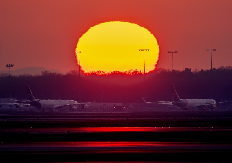 Germany Airport Strike Travelers stand in front of a display board in an airport terminal in Hamburg, Germany, in the morning of Tuesday, March 22, 2022. Due to a warning strike by the trade union ver.di, the security checkpoint remains closed all day and no departures take place. (Daniel Bockwoldt/dpa via AP)