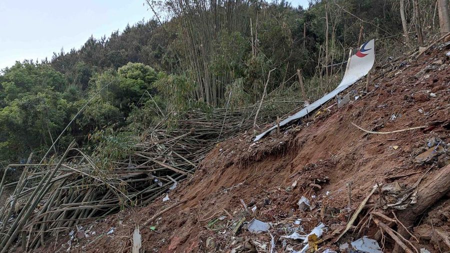 In this photo taken by mobile phone released by Xinhua News Agency, a piece of wreckage of the China Eastern's flight MU5735 are seen after it crashed on the mountain in Tengxian County, south China's Guangxi Zhuang Autonomous Region on Monday, March 21, 2022. A China Eastern Boeing 737-800 with 132 people on board crashed in a remote mountainous area of southern China on Monday, officials said, setting off a forest fire visible from space in the country's worst air disaster in nearly a decade. (Xinhua via AP)