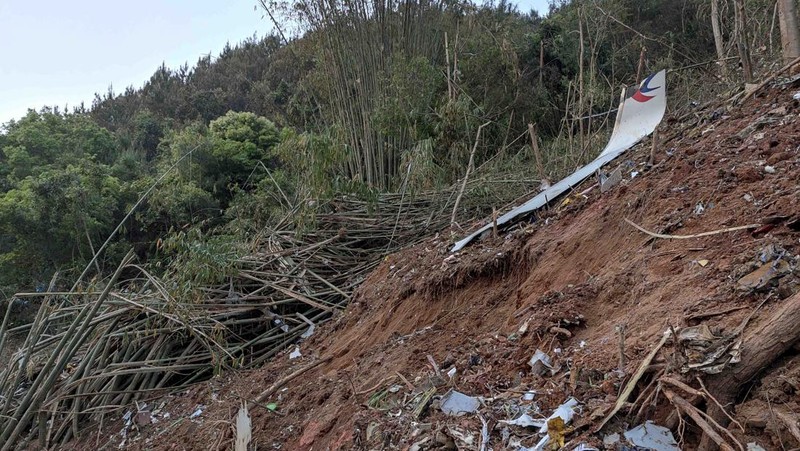 In this photo taken by mobile phone released by Xinhua News Agency, a piece of wreckage of the China Eastern's flight MU5735 are seen after it crashed on the mountain in Tengxian County, south China's Guangxi Zhuang Autonomous Region on Monday, March 21, 2022. A China Eastern Boeing 737-800 with 132 people on board crashed in a remote mountainous area of southern China on Monday, officials said, setting off a forest fire visible from space in the country's worst air disaster in nearly a decade. (Xinhua via AP)