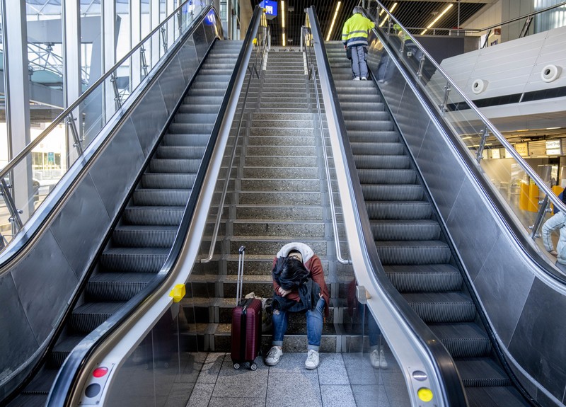 Germany Airport Strike Travelers stand in front of a display board in an airport terminal in Hamburg, Germany, in the morning of Tuesday, March 22, 2022. Due to a warning strike by the trade union ver.di, the security checkpoint remains closed all day and no departures take place. (Daniel Bockwoldt/dpa via AP)