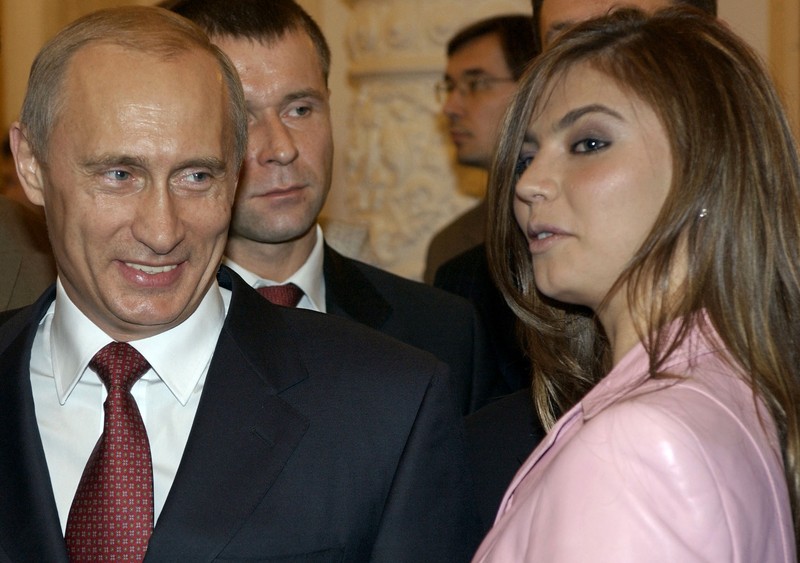 FILE - In this Thursday, Nov. 4, 2004 file photo President Vladimir Putin, left, speaks with gymnast Alina Kabaeva at a Kremlin banquet in Moscow, Russia. Alina Kabayeva, the Olympic gold gymnast whose relationship with Russian President Vladimir Putin is the subject of wide speculation, is resigning from her seat in the national parliament. Russian news reports say Kabayeva on Monday, Sept 15, 2014,  asked to step down in order to undertake other unspecified work. (AP Photo/ITAR-TASS, Presidential Press Service, File)