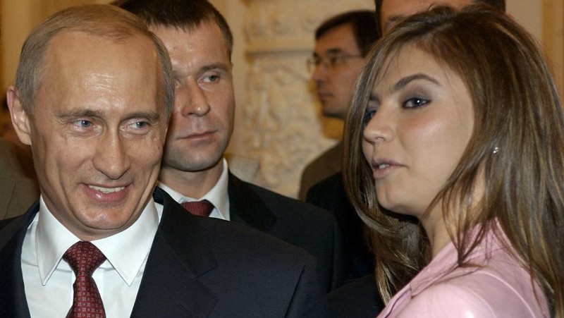 FILE - In this Thursday, Nov. 4, 2004 file photo President Vladimir Putin, left, speaks with gymnast Alina Kabaeva at a Kremlin banquet in Moscow, Russia. Alina Kabayeva, the Olympic gold gymnast whose relationship with Russian President Vladimir Putin is the subject of wide speculation, is resigning from her seat in the national parliament. Russian news reports say Kabayeva on Monday, Sept 15, 2014,  asked to step down in order to undertake other unspecified work. (AP Photo/ITAR-TASS, Presidential Press Service, File)