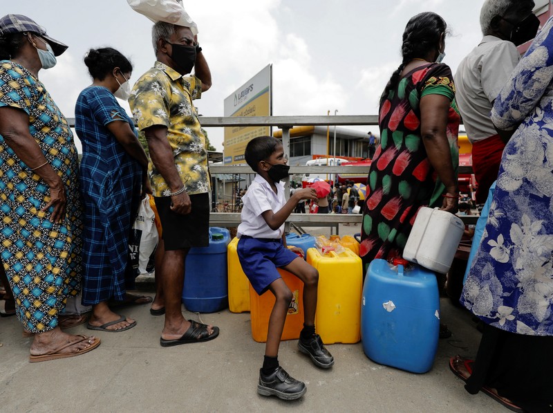 People stand in a long queue to buy kerosene oil for kerosene cookers amid a shortage of domestic gas due to country's economic crisis, at a fuel station in Colombo, Sri Lanka March 21, 2022. REUTERS/Dinuka Liyanawatte