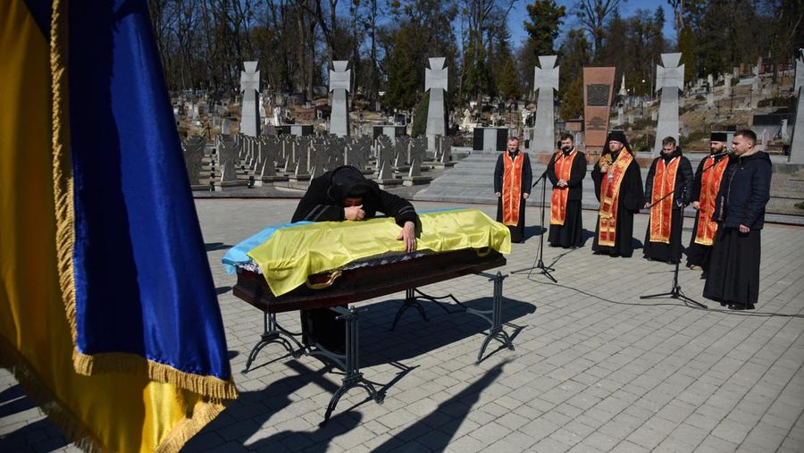The mother of Major Ivan Skrypnyk, who died as a result of Russia's missile attack on the Ukrainian military base in Yavoriv, reacts during his funeral, following Russia's invasion of Ukraine, at Lychakiv Cemetery, in Lviv, Ukraine, March 17, 2022. REUTERS/Pavlo Palamarchuk