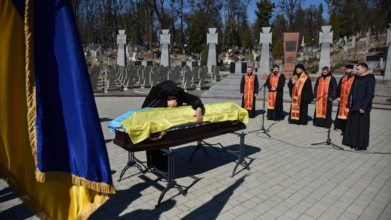 The mother of Major Ivan Skrypnyk, who died as a result of Russia's missile attack on the Ukrainian military base in Yavoriv, reacts during his funeral, following Russia's invasion of Ukraine, at Lychakiv Cemetery, in Lviv, Ukraine, March 17, 2022. REUTERS/Pavlo Palamarchuk