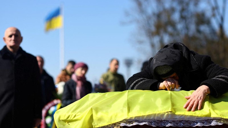 The mother of Major Ivan Skrypnyk, who died as a result of Russia's missile attack on the Ukrainian military base in Yavoriv, reacts during his funeral, following Russia's invasion of Ukraine, at Lychakiv Cemetery, in Lviv, Ukraine, March 17, 2022. REUTERS/Pavlo Palamarchuk