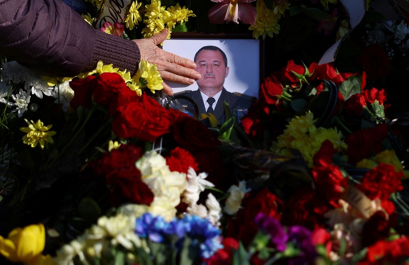 The mother of Major Ivan Skrypnyk, who died as a result of Russia's missile attack on the Ukrainian military base in Yavoriv, reacts during his funeral, following Russia's invasion of Ukraine, at Lychakiv Cemetery, in Lviv, Ukraine, March 17, 2022. REUTERS/Pavlo Palamarchuk