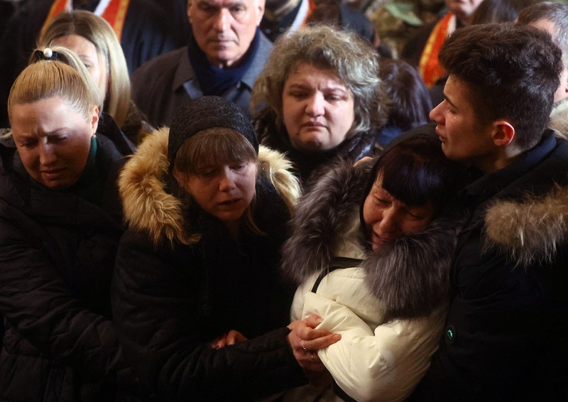 The mother of Major Ivan Skrypnyk, who died as a result of Russia's missile attack on the Ukrainian military base in Yavoriv, reacts during his funeral, following Russia's invasion of Ukraine, at Lychakiv Cemetery, in Lviv, Ukraine, March 17, 2022. REUTERS/Pavlo Palamarchuk