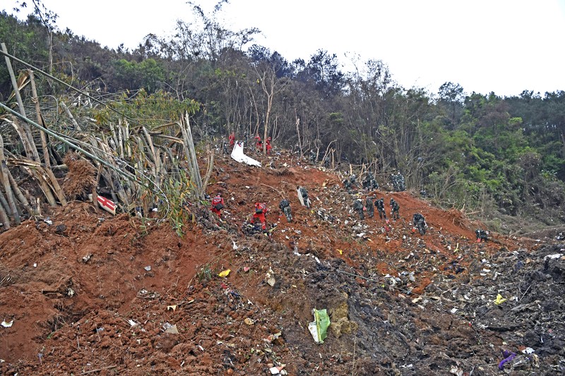 China Plane Crash In this photo released by Xinhua News Agency, rescue workers search for the black boxes at a plane crash site in Tengxian county, southwestern China's Guangxi Zhuang Autonomous Region, Tuesday, March 22, 2022. A China Eastern flight 5735 carrying 123 passengers and nine crew members crashed outside the city of Wuzhou in the Guangxi region while flying from Kunming, the capital of the southwestern province of Yunnan, to Guangzhou, an industrial center not far from Hong Kong on China's southeastern coast. It ignited a fire big enough to be seen on NASA satellite images before firefighters could extinguished it. (Zhou Hua/Xinhua via AP)