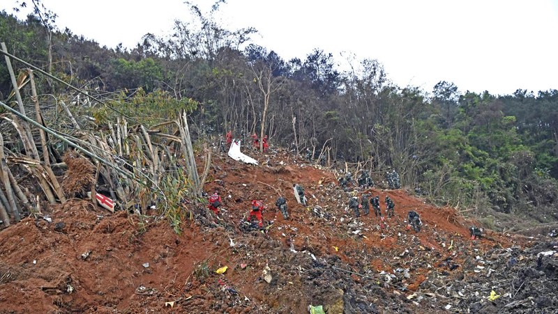 In this photo released by Xinhua News Agency, rescue workers search for the black boxes at a plane crash site in Tengxian county, southwestern China's Guangxi Zhuang Autonomous Region, Tuesday, March 22, 2022. A China Eastern flight 5735 carrying 123 passengers and nine crew members crashed outside the city of Wuzhou in the Guangxi region while flying from Kunming, the capital of the southwestern province of Yunnan, to Guangzhou, an industrial center not far from Hong Kong on China's southeastern coast. It ignited a fire big enough to be seen on NASA satellite images before firefighters could extinguished it. (Zhou Hua/Xinhua via AP)