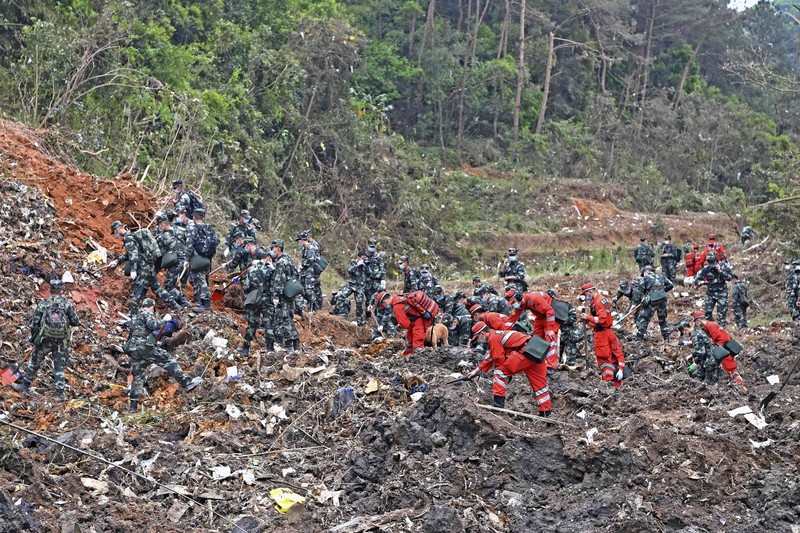 China Plane Crash In this photo released by Xinhua News Agency, rescue workers search for the black boxes at a plane crash site in Tengxian county, southwestern China's Guangxi Zhuang Autonomous Region, Tuesday, March 22, 2022. A China Eastern flight 5735 carrying 123 passengers and nine crew members crashed outside the city of Wuzhou in the Guangxi region while flying from Kunming, the capital of the southwestern province of Yunnan, to Guangzhou, an industrial center not far from Hong Kong on China's southeastern coast. It ignited a fire big enough to be seen on NASA satellite images before firefighters could extinguished it. (Zhou Hua/Xinhua via AP)