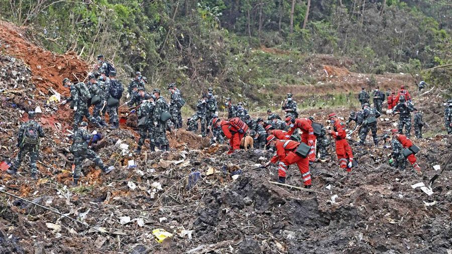 In this photo released by Xinhua News Agency, rescue workers search for the black boxes at a plane crash site in Tengxian county, southwestern China's Guangxi Zhuang Autonomous Region, Tuesday, March 22, 2022. A China Eastern flight 5735 carrying 123 passengers and nine crew members crashed outside the city of Wuzhou in the Guangxi region while flying from Kunming, the capital of the southwestern province of Yunnan, to Guangzhou, an industrial center not far from Hong Kong on China's southeastern coast. It ignited a fire big enough to be seen on NASA satellite images before firefighters could extinguished it. (Zhou Hua/Xinhua via AP)
