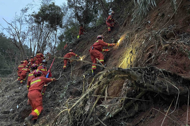 China Plane Crash In this photo released by Xinhua News Agency, rescue workers search for the black boxes at a plane crash site in Tengxian county, southwestern China's Guangxi Zhuang Autonomous Region, Tuesday, March 22, 2022. A China Eastern flight 5735 carrying 123 passengers and nine crew members crashed outside the city of Wuzhou in the Guangxi region while flying from Kunming, the capital of the southwestern province of Yunnan, to Guangzhou, an industrial center not far from Hong Kong on China's southeastern coast. It ignited a fire big enough to be seen on NASA satellite images before firefighters could extinguished it. (Zhou Hua/Xinhua via AP)