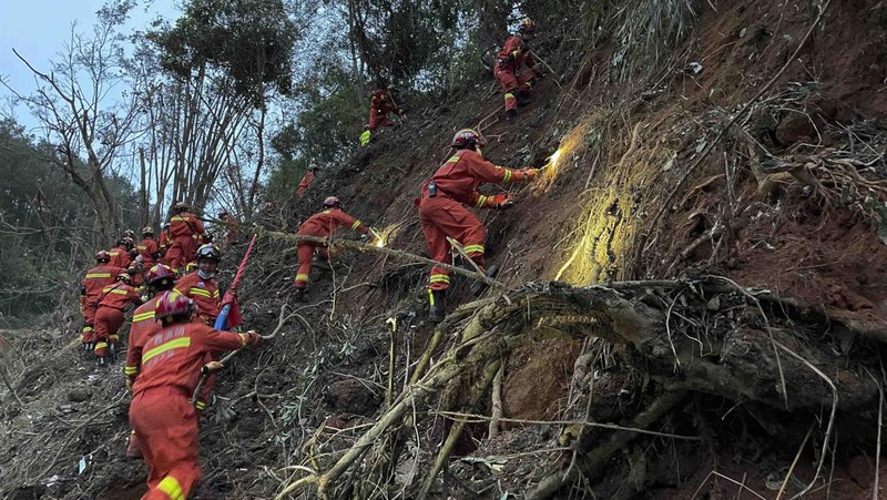 In this photo released by Xinhua News Agency, rescue workers search for the black boxes at a plane crash site in Tengxian county, southwestern China's Guangxi Zhuang Autonomous Region, Tuesday, March 22, 2022. A China Eastern flight 5735 carrying 123 passengers and nine crew members crashed outside the city of Wuzhou in the Guangxi region while flying from Kunming, the capital of the southwestern province of Yunnan, to Guangzhou, an industrial center not far from Hong Kong on China's southeastern coast. It ignited a fire big enough to be seen on NASA satellite images before firefighters could extinguished it. (Zhou Hua/Xinhua via AP)