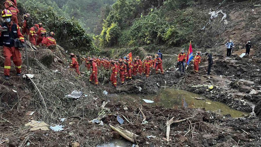 In this photo released by Xinhua News Agency, rescue workers search for the black boxes at a plane crash site in Tengxian county, southwestern China's Guangxi Zhuang Autonomous Region, Tuesday, March 22, 2022. A China Eastern flight 5735 carrying 123 passengers and nine crew members crashed outside the city of Wuzhou in the Guangxi region while flying from Kunming, the capital of the southwestern province of Yunnan, to Guangzhou, an industrial center not far from Hong Kong on China's southeastern coast. It ignited a fire big enough to be seen on NASA satellite images before firefighters could extinguished it. (Zhou Hua/Xinhua via AP)
