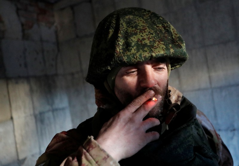UKRAINE-CRISIS/DONETSK-REGION A service member of pro-Russian troops in uniform without insignia handles a mortar round at the weapons depot during Ukraine-Russia conflict near Marinka, in the Donetsk Region, Ukraine March 22, 2022. REUTERS/Alexander Ermochenko TPX IMAGES OF THE DAY
