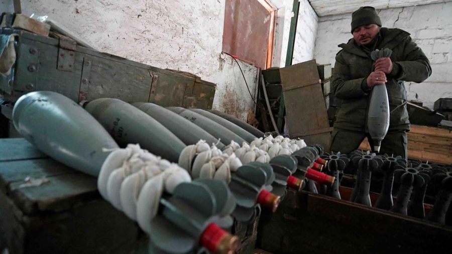 A service member of pro-Russian troops in uniform without insignia handles a mortar round at the weapons depot during Ukraine-Russia conflict near Marinka, in the Donetsk Region, Ukraine March 22, 2022. REUTERS/Alexander Ermochenko TPX IMAGES OF THE DAY