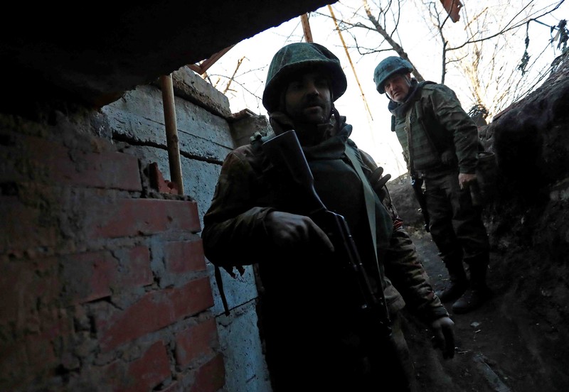 UKRAINE-CRISIS/DONETSK-REGION A service member of pro-Russian troops in uniform without insignia handles a mortar round at the weapons depot during Ukraine-Russia conflict near Marinka, in the Donetsk Region, Ukraine March 22, 2022. REUTERS/Alexander Ermochenko TPX IMAGES OF THE DAY