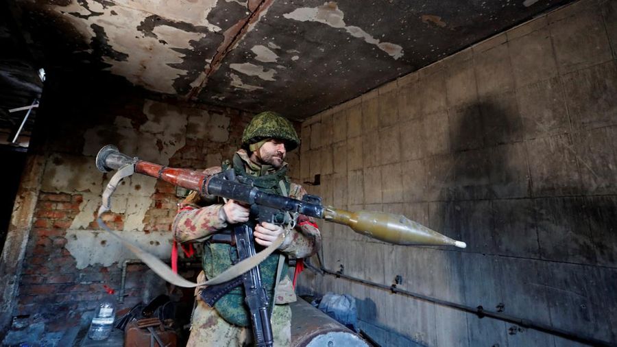 A service member of pro-Russian troops in uniform without insignia handles a mortar round at the weapons depot during Ukraine-Russia conflict near Marinka, in the Donetsk Region, Ukraine March 22, 2022. REUTERS/Alexander Ermochenko TPX IMAGES OF THE DAY