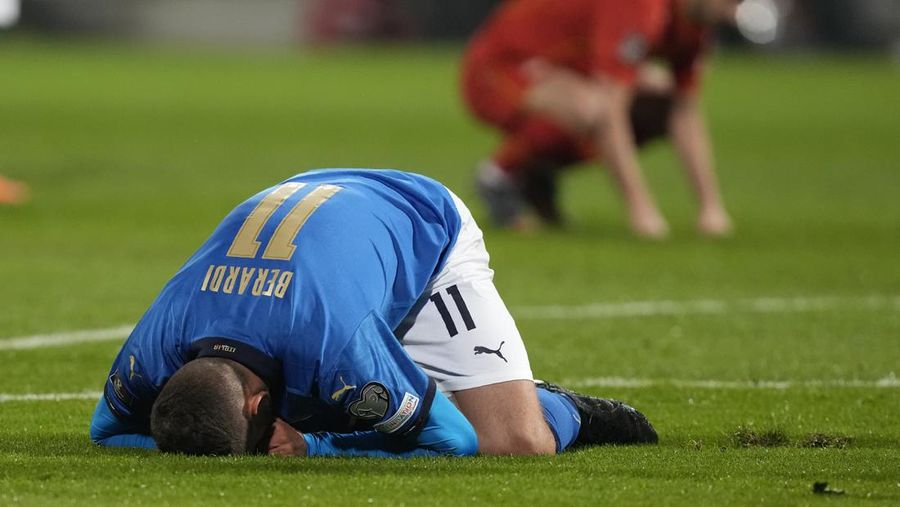 North Macedonia players celebrate as Italy's Alessandro Bastoni reacts after his team's got eliminated at the end of the World Cup qualifying play-off soccer match between Italy and North Macedonia, at Renzo Barbera stadium, in Palermo, Italy, Thursday, March 24, 2022. North Macedonia won 1-0. (AP Photo/Antonio Calanni)