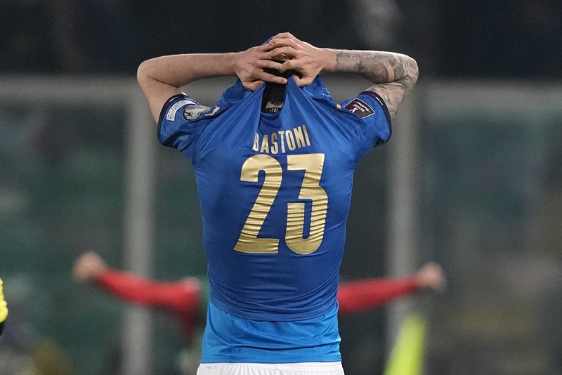 Italy North Macedonia WCup 2022 Soccer North Macedonia players celebrate as Italy's Alessandro Bastoni reacts after his team's got eliminated at the end of the World Cup qualifying play-off soccer match between Italy and North Macedonia, at Renzo Barbera stadium, in Palermo, Italy, Thursday, March 24, 2022. North Macedonia won 1-0. (AP Photo/Antonio Calanni)